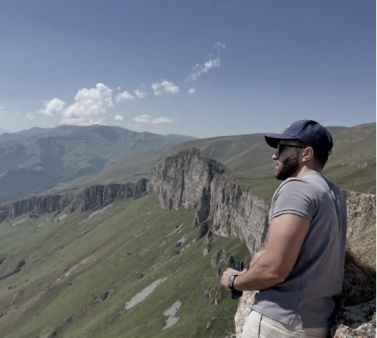 Harout Chouljian looking out over a mountain ridge